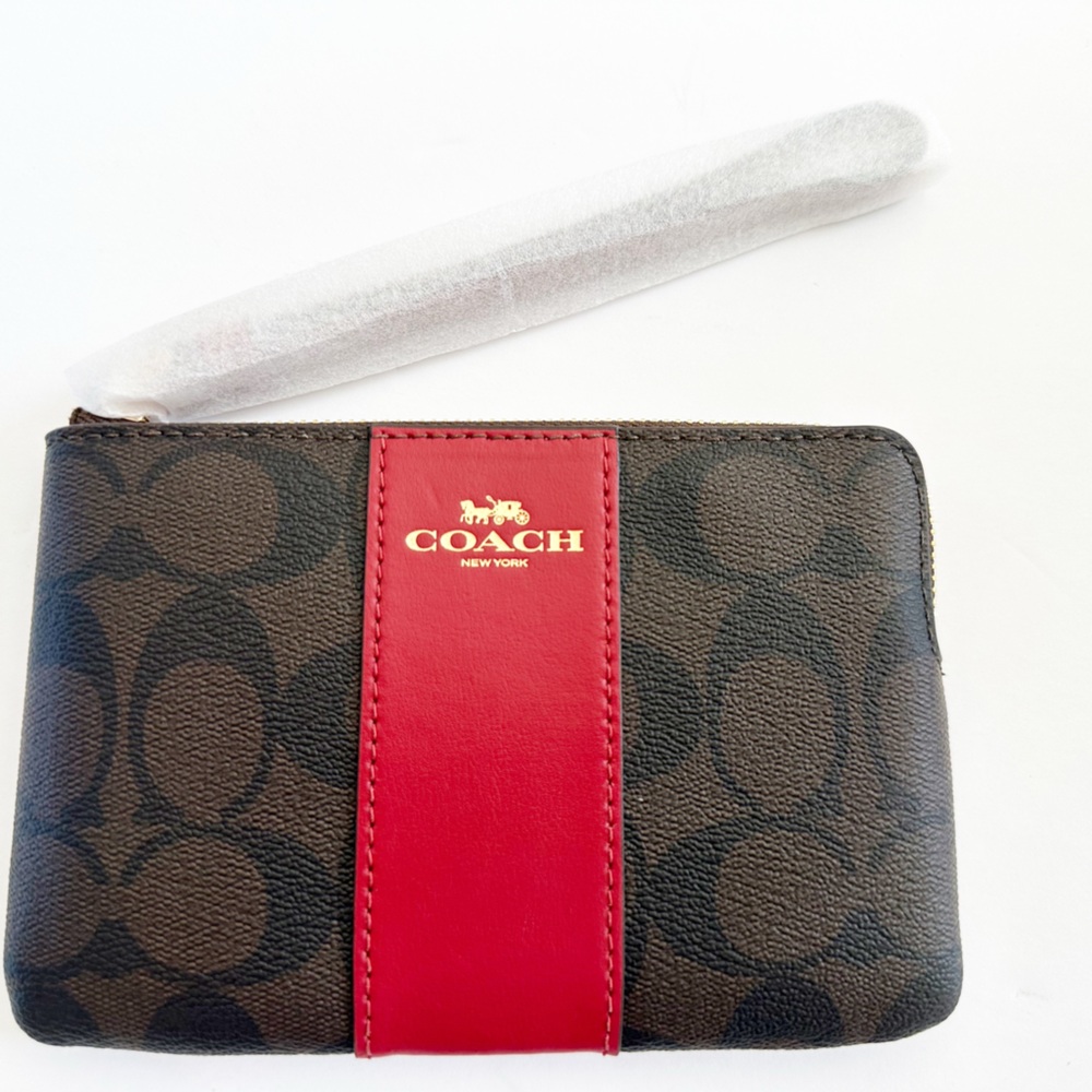 Brown and red logo Coach wristlet